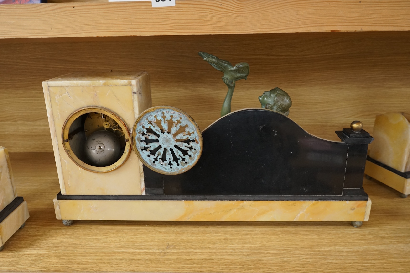 An Art Deco marble and slate clock garniture surmounted with a woman and birds, 52cm wide